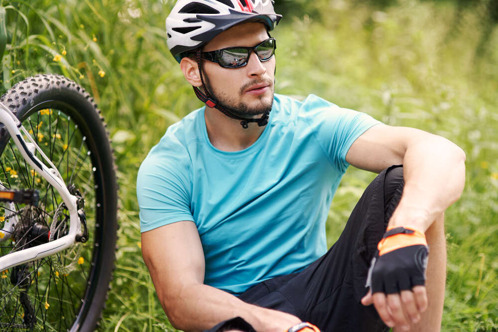 A cyclist wearing a helmet and cycling glasses