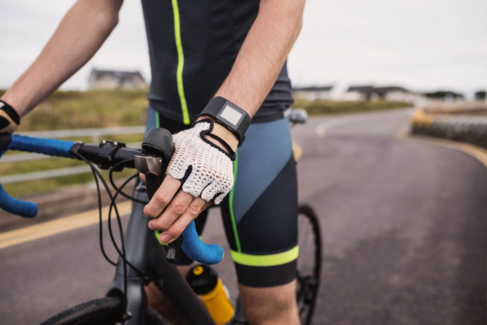 A cyclist wearing white fingerless gloves